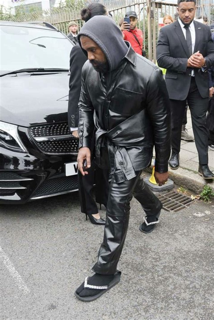 
Kanye West Steps Out at Burberry Show in Bedazzled Flip Flops and Socks: ‘Don’t Talk to Me’ 